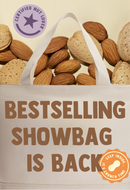 Tote bag with almonds, 'Certified Nut Lover' badge, and promotional text on a beige background